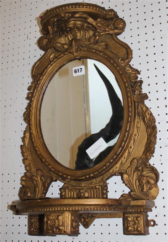 Oval gilt frame wall mirror with shelf